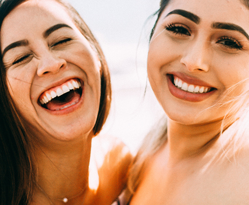 Two women laughing and smiling