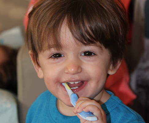 child brushing his teeth