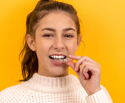 Woman holding clear aligners