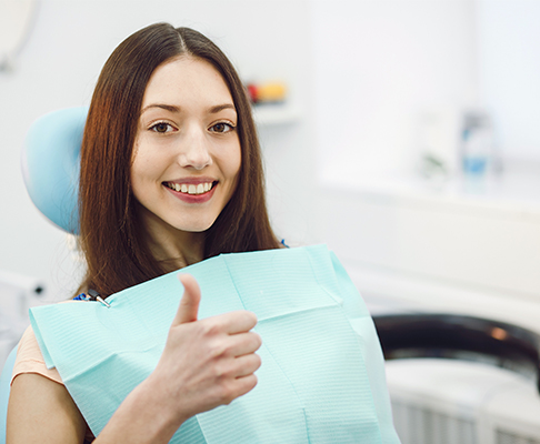 Woman sat in dental chair for check up