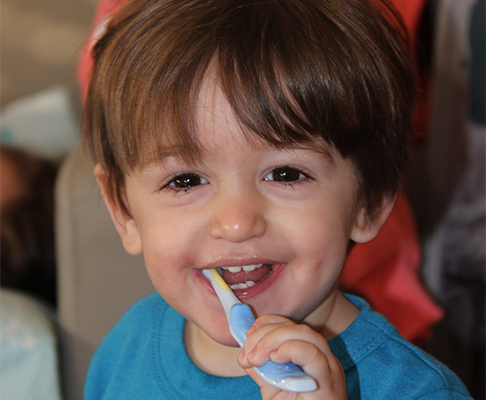 Child brushing his teeth